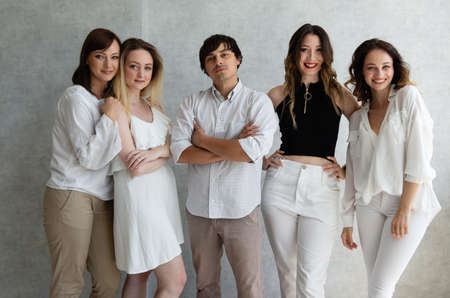 Happy diverse professional business team stand in office looking at camera, smiling young and old workers group of employees together present as human resource, corporate equality concept, portraitの写真素材