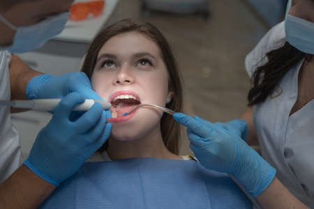Attractive young woman in a dental clinic with a male dentist.の写真素材