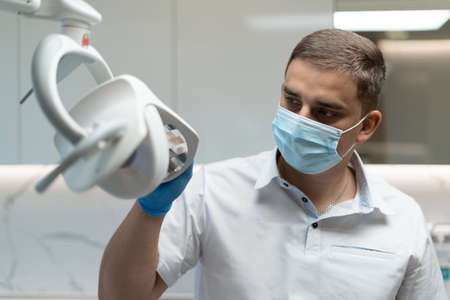 of the doctors face, he shines a lamp at the patient.の写真素材