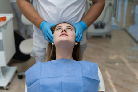 Dentist curing a female patientの写真素材
