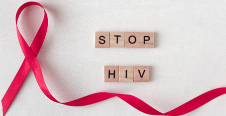 letters. Concept for World AIDS Day. Red ribbon near wooden letters. Baner, copy space. stop hiv