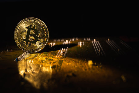 one gold bitcoin coin on the motherboard