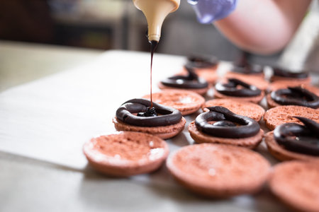The chocolate filling for the pasta is poured from the bottle. The process of making puffed cookies...