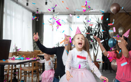 cheerful and laughing schoolgirl girl cheerfully rejoices. Birthday celebration concept. Cheerful family holidayの写真素材