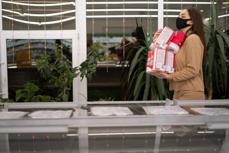 Women wearing glasses and wearing disposable medical mask shopping Toilet paper in supermarketの写真素材