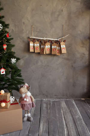 Christmas festive craft packaging advent calendar hanging on the wall, room decor in winter holiday, gray background.の写真素材