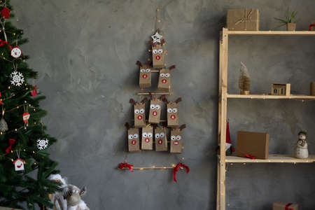 Christmas background with advent calendar and Christmas tree on the wall. New Years decor.の写真素材