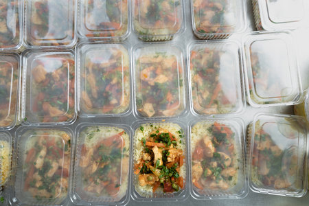 food delivery in the restaurant. Business lunch in an eco-friendly plastic container, ready for delivery. View from above. Office Lunch boxes with rice meals. Food is taken away. Meals, breakfast.の写真素材