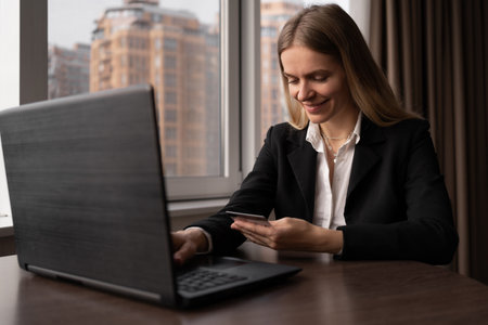 Happy business woman shopping online with laptop in the office. caucasian woman lifestyle online shopping. Ordering goods and paying by card on site.の写真素材