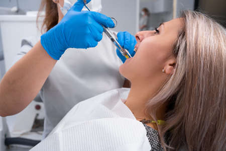 close-up portrait caucasian woman at the reception at the dentist. The doctor makes an injection with dental anesthesia. Medicine, dentist and healthcare concept.の写真素材