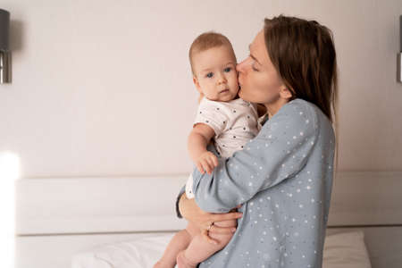 Caucasian mother and child close up. family, motherhood, parenting, people and child care concept. happy mother kissing adorable baby on white background. happy family concept. high quality photoの写真素材