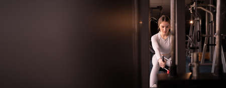 portrait of a woman performing deadlift on a power simulator. intense workout in the gym. Banner,の写真素材