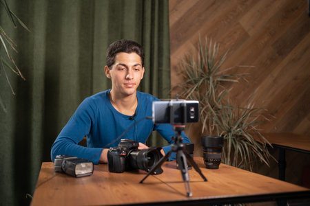 Video training for beginner photographers, online courses. A Muslim man records a video review of...