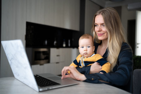 businesswoman mother woman working with baby at laptop, remote work at home young mother with child,...