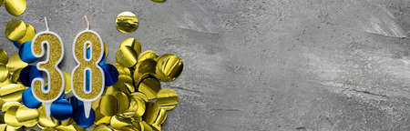 festive number thirty-eight. Birthday or anniversary card with the inscription 38. gray concrete background. Anniversary celebration. Banner. copy spaceの写真素材