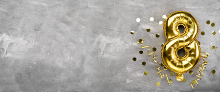Yellow foil balloon number, number eight on a concrete background. Birthday card with inscription 8. Anniversary concept. for anniversary, birthday, new year celebration. banner, copy space.の写真素材