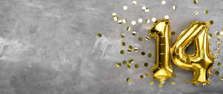 Yellow foil balloon number, number fourteen on a concrete background. 14th birthday card. Anniversary concept. for anniversary, birthday, new year celebration. banner, copy space.の写真素材