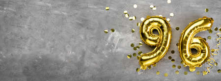 Yellow foil balloon number, number ninety-six on a concrete background. Greeting card with the inscription 96. Anniversary concept. for anniversary, birthday, new year celebration. banner,の写真素材