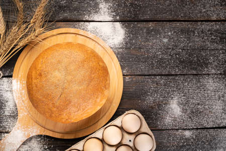 round bran bread on a wooden background, top view. copyspace.の写真素材