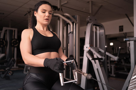 determined woman losing weight in the gym and exercising. The concept of sports and recreation. A...