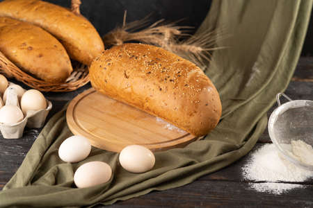 Fresh bran bread on a wooden table. Side view withの写真素材