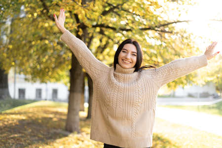 happy girl enjoying life and freedom in autumn in nature, caucasian woman relaxing outdoors, concept of happinessの写真素材