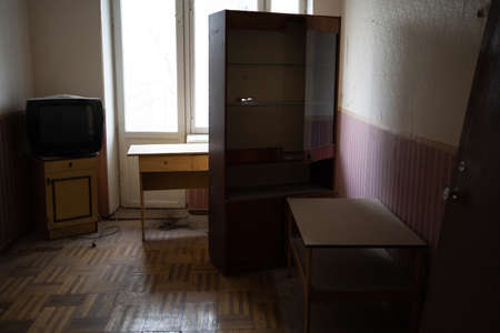 old abandoned room with dirty broken furniture and an old TVの写真素材