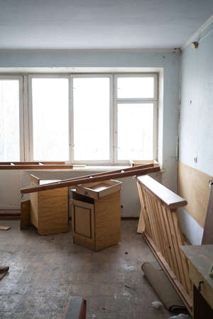 an abandoned room with a destroyed floor, walls and cobwebs, broken furniture. copyspace.の写真素材