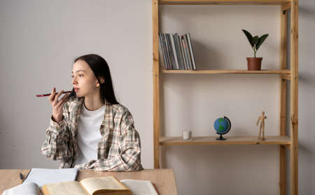 Caucasian girl student using virtual assistant recording audio message, recording audio call through smartphone microphone, gadget user conceptの写真素材
