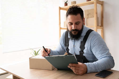 Small business start-up entrepreneur, SME freelance man working with box, adult Indian small business owner, online market office, SME delivery, e-commerce, seller conceptの写真素材