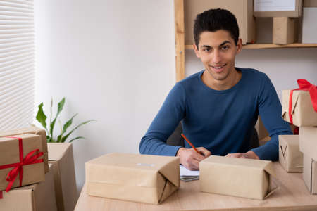 muslim business man small and medium business checking customer orders online at home. Starting a small business is an SME entrepreneurial freelance. Internet business, work from home concept. copyspace.の写真素材