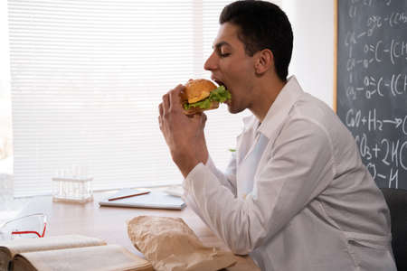 arabic teacher school lunch. Education and learning. Tutor in classroom. Studying, fast food in schoolの写真素材