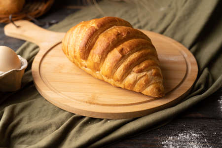 croissant on wooden board rustic background, homemade bakingの写真素材