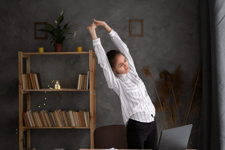 unhappy young businesswoman suffering from backache, problem after long hours sedentary work,...