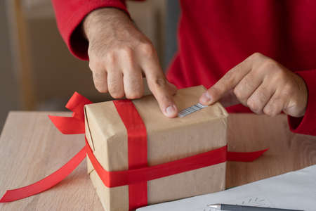 Santa Claus packing Merry Christmas gift box, worker delivering parcel standing in workshop. Big sale for Christmas. Xmas fast express shipping delivery conceptの写真素材