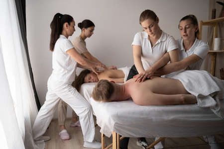 Health wellness massage training.Teacher helping student training to become masseuseの写真素材