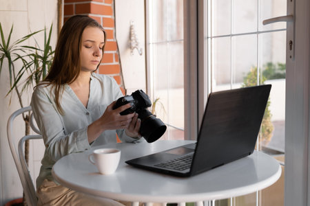 beautiful creative woman photographer working in cafe using laptop with camera. Freelance online marketing business people employees. freelance creative artist fe business.の写真素材