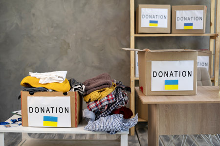 Donation box with clothes on the table, help to ukraine from volunteersの写真素材