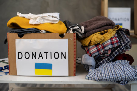 Donation box with clothes. boxes full with stuff for donate. Help poor. Cardboard box with clothes for charity. Donationの写真素材