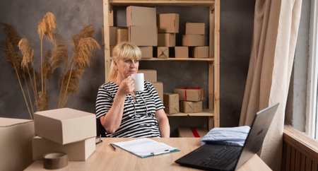 Start up small businesses SME owners female entrepreneurs working and drinking coffee, box and check online orders to prepare to pack the boxes, sme business ideas onlineの写真素材