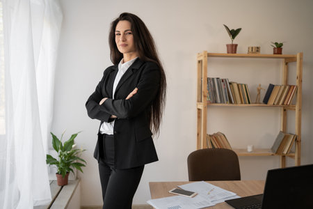 Portrait of a modern beautiful business woman in the office. Cross armsの写真素材