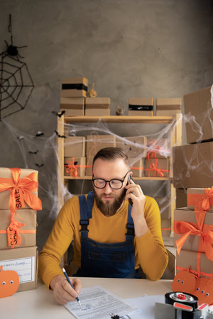 SME freelance man working with packaging startup entrepreneur small business owner at home on Halloween, Online business seller packaging, SME, holiday sale, deliveryの写真素材