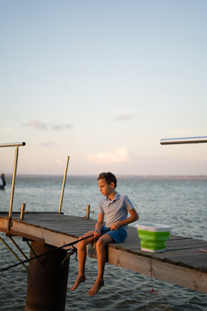 Young cute boy fishing on a lake in a summer day. Fishingの写真素材