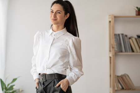 Portrait of young brunette woman in office, businesswoman in office interior, business and entrepreneurの写真素材