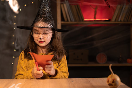 Halloween preparation kids craft. Little children doing crafts at home at night. Halloween partyの写真素材
