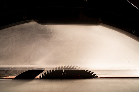 Circular table saw disc with carbide teeth on furniture factory, close-up. copy spaceの写真素材