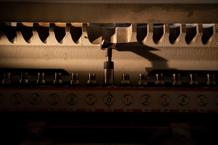 Drilling machine makes a hole in a wooden slab, close up. Process of production and manufacture at furniture factory. macro shot. copy spaceの写真素材