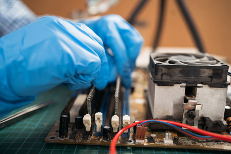 Installing random access memory into PC, installing memory on a computer motherboard, woman repairing computer hardware in service center. close upの写真素材