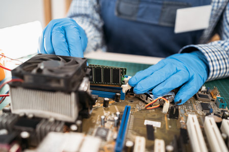 Installing random access memory into PC. Computer service engineer technician workplace repairing fixing broken components upgrade system, motherboard, copy spaceの写真素材