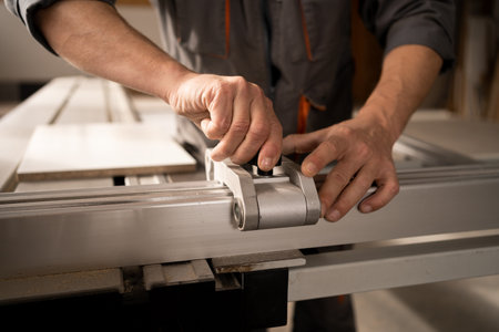 Man working on automatic woodworking machine in furniture factory. close upの写真素材